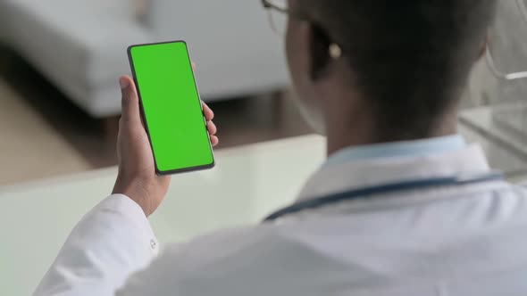 Young African Doctor Using Smartphone with Chroma Screen alt