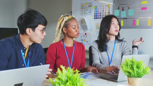 brainstorming about mobile app interface workflow design on table with coworker breif alt