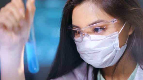 Asian Female Researcher in Protective Glasses Mask Making Chemical Examination of Toxic Substance alt