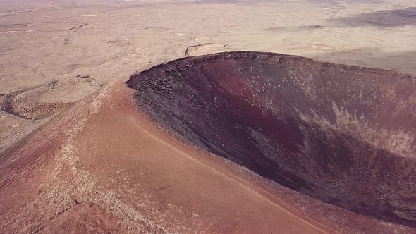Panning Lajares' volcano's crater with a drone in Fuerteventura, Canary Islands, Spain alt