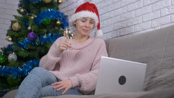 Clinking glass of champagne online. alt