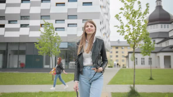 Student Girl with Backpack Walking to the University Building alt