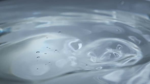 Water Drop Falls on the Water Surface in Slow Motion Macro Shot alt