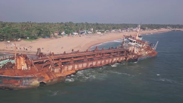 Old shipwreck on a beach near Varkala, Kerala, India. Aerial drone view alt