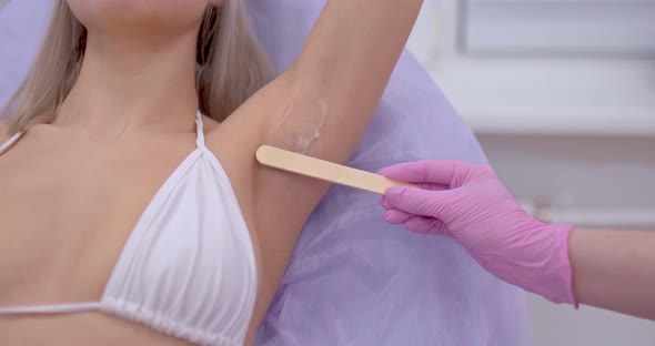 Woman is Applying Gel for Laser Hair Removal on Her Armpits alt
