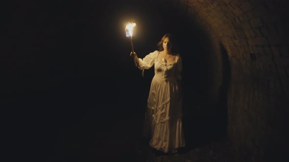 Girl with a torch in Medieval Dungeon