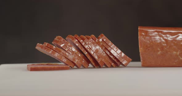 Slicing Meat. With A Sharp Knife Cuts Thin Slices Of Sausage. alt