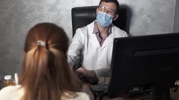 The family doctor writes a prescription for the patient's treatment during the consultation alt