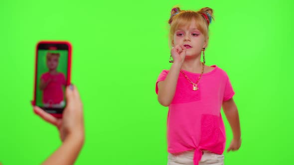 Happy Little Kid Girl Blogger Front of Phone Camera Record Video Enjoy Dance Content on Chroma Key alt