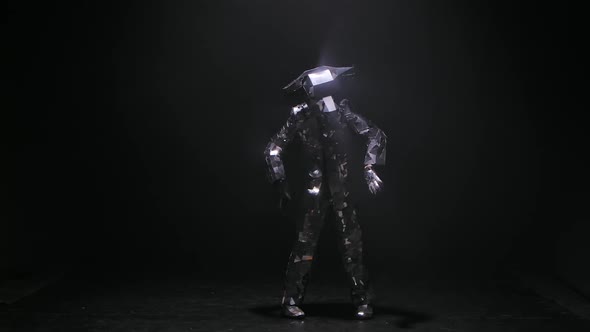 Person in Shining Silver Costume Made of Mirrors with a Bull's Head and Horns Is Dancing Joyfully at alt