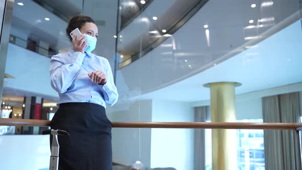 Masked Busy on Phone Woman Taking Hotel Lift Up alt