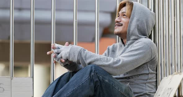 Homeless man sitting on the overpass alt