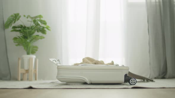 Packing suitcase getting ready for road trip preparing luggage for summer vacation. alt