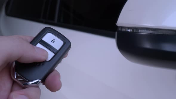 Car key remote control. Locking and unlocking the car by the car key remote control. Pressing button