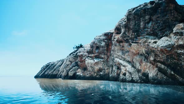 Beautiful Rocky Cliff in the Middle of the Sea alt