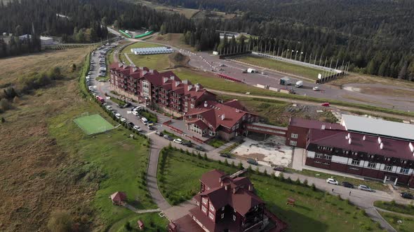 Special sports camp in green pine trees forest in summer with training tracks for biathlon alt