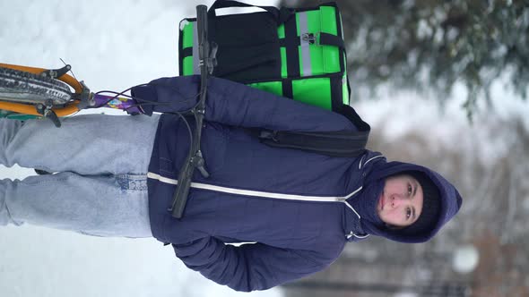 Courier Is Delivering Food with Backpack at Winter