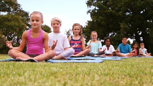 Group of children performing yoga alt