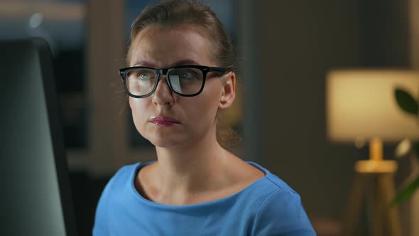 Woman in Glasses Looking on the Monitor and Surfing Internet alt