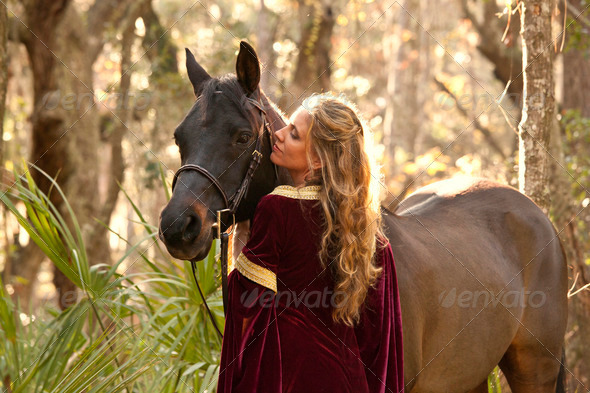 woman in medieval dress with horse - Stock Photo - Images