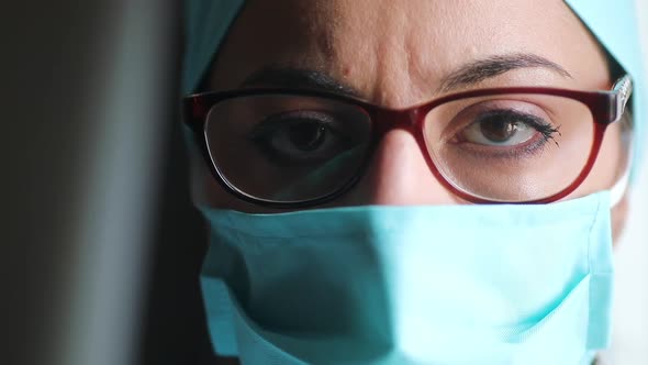 Woman doctor wearing a surgical mask and glasses