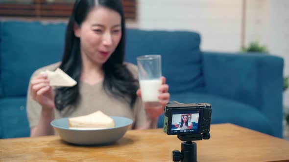 Asian women using camera streaming and recording vlog video about the benefit for broadcast online. alt