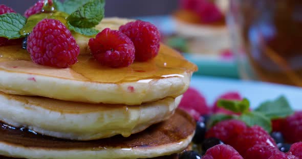 Pouring Honey on Stack of Pancakes alt