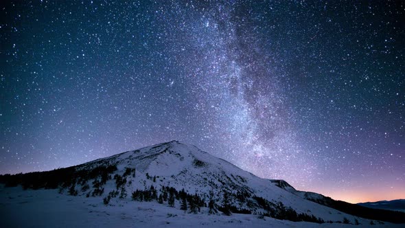 Twinkling milky way above the snowy peaks of the Carpathian Mountains. Cinemagraph. alt