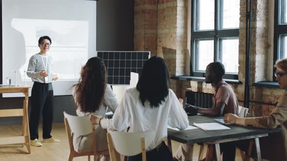 Asian Woman Giving Presentation about Renewable Energy alt