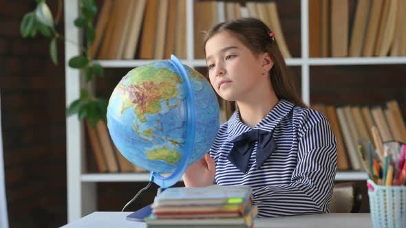 Student Child Studying Earth Globe in Library.