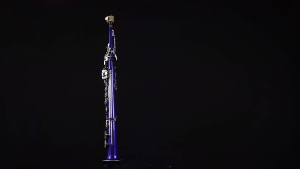 Rotating Blue Soprano Saxophone On A Black Background.