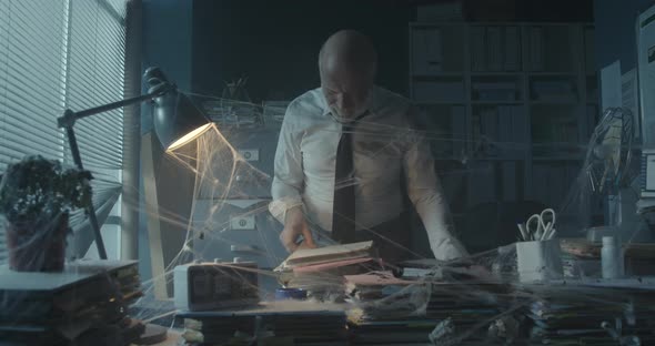 Businessman searching for files in the abandoned office