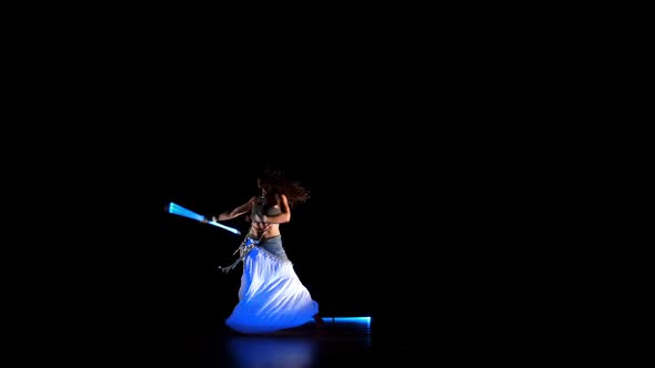 Beautiful Woman Dance With Neon Staffs In Ultraviolet Light  alt