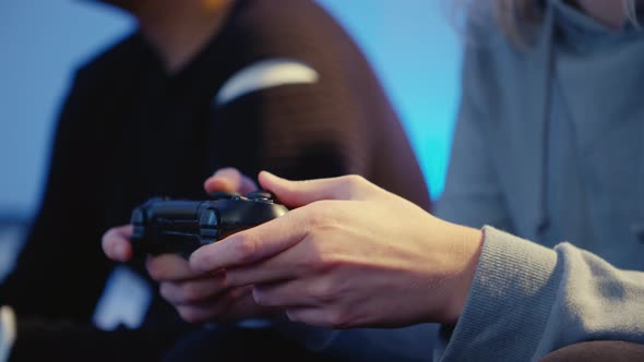 Close-up of hands of a girl gaming with her boyfriend alt