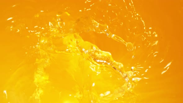 Super Slow Motion Shot of Pouring Fresh Orange Juice Into Whirl at 1000 Fps alt