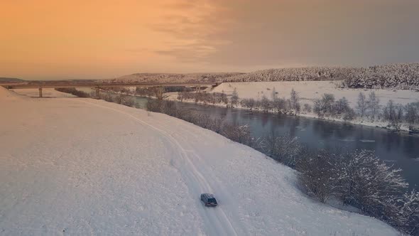 Drone shooting of a river against the background of a forest and a bridge alt