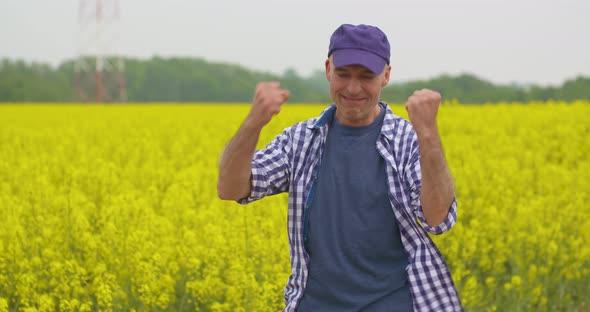 Farmer Examining Agriculture Field on Farm alt