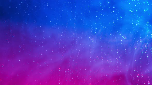 Background is Transparent Glass with Drops Illuminated By a Police Flasher alt