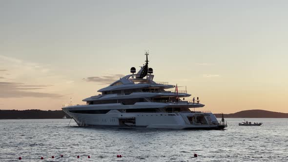Luxury Motor Yacht Anchored In The Coast Of Hvar Island At Dusk In Croatia. - wide shot alt