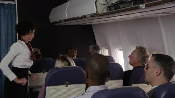 Flight attendant talking to passengers ready to take off
