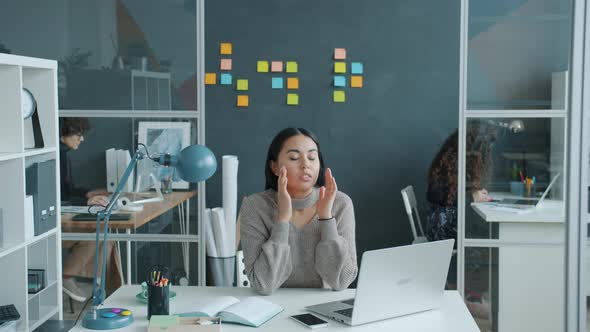 Asian Girl Employee Feeling Headache Working with Laptop in Modern Coworking Space alt