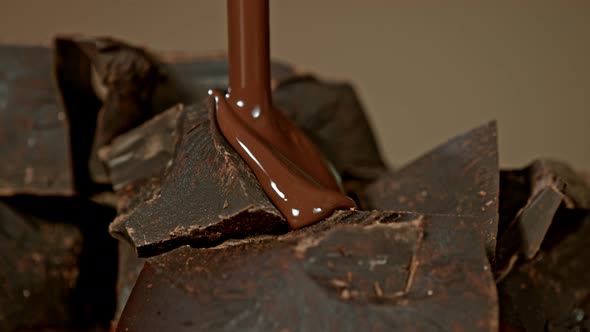 Super Slow Motion Shot of Pouring Melted Chocolate on Raw Chocolate Chunks at 1000 Fps alt