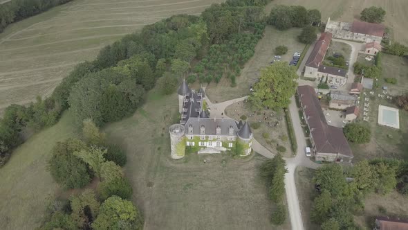 Aerial view of french castle Chateau de La Cote Rural summer landscape green meadows fields trees 