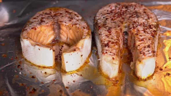 Salmon is baked in the oven close-up. Baking salmon steak. Salmon steak with spices roasting alt