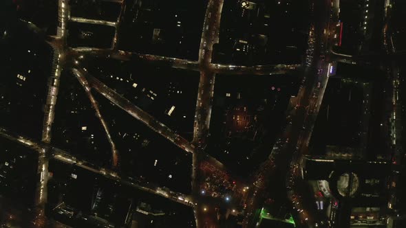 Birds Eye Shot of Cars Driving on Streets in Urban Neighbourhood in Night City alt