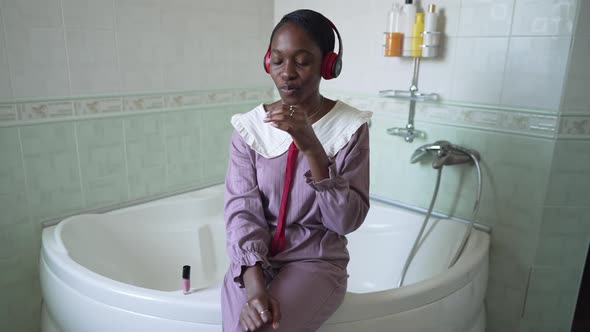 Front View Portrait of Confident African American Young Woman Bragging Nail Polish in Slow Motion alt