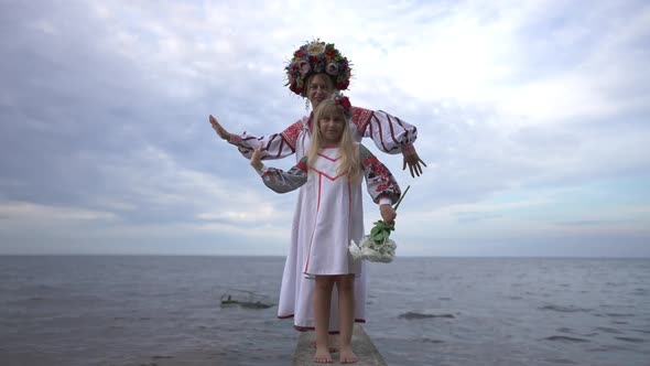 Wide Shot Portrait of Confident Happy Ukrainian Daughter and Mother in Traditional Embroidered alt