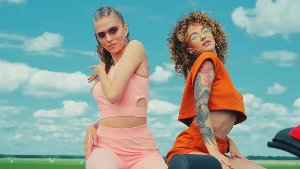 Portrait of Two Young Beautiful Hipster Girls in Red Convertible Car alt