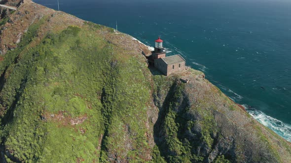 Aerial Close Up Overlook of the Historical Building of Lighthouse with Red Roof alt