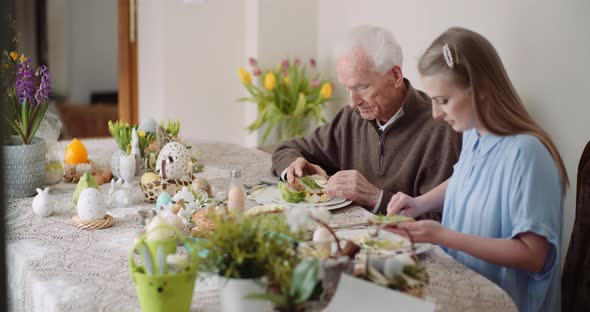 Happy Easter - Grandfather and Granddaughter Spending Easter Together at Home. alt